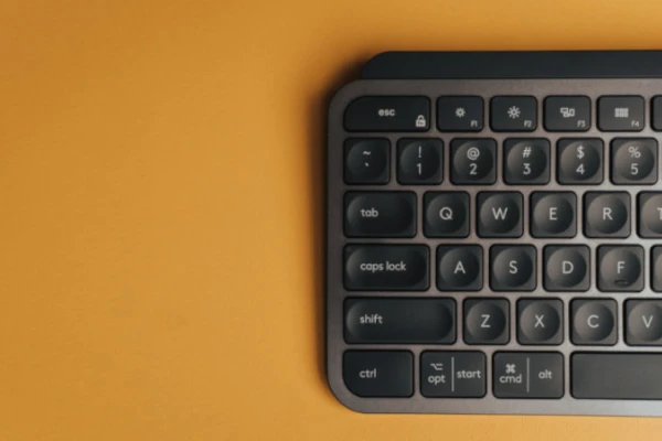 Image of a keyboard, the left half, on a yellow-ish background