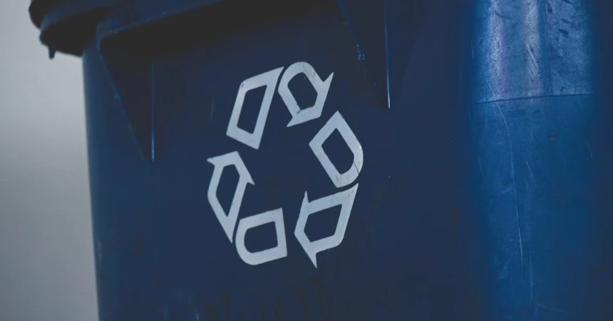 Picture of a blue garbage container with a recycle icon on it