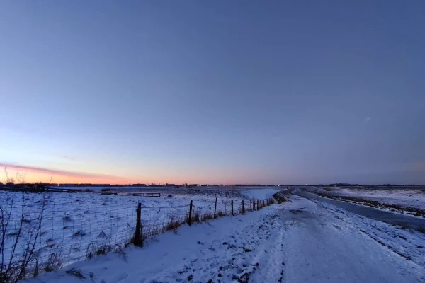 Just before sunrise on a snowy landscape