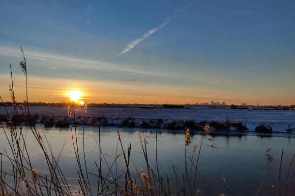 Sunrise with the Rotterdam skyline seen next to it.