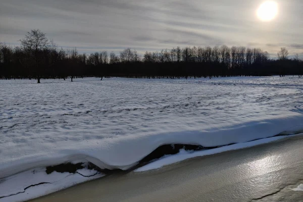 Snowy field and a cloudy sunrise