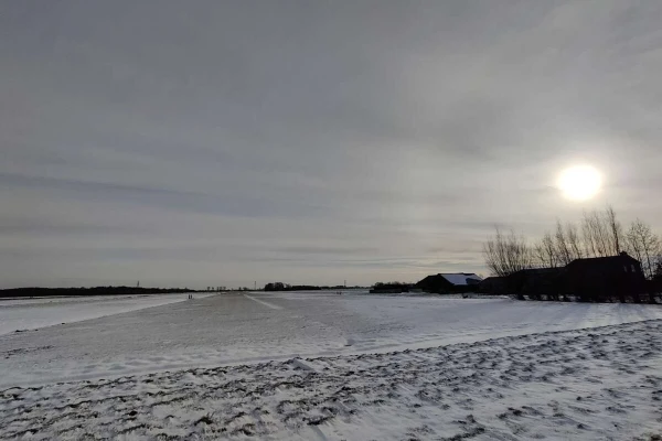 Snowy field and a cloudy sunrise