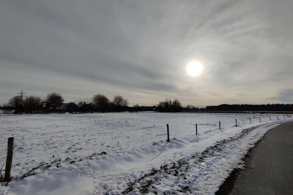 Cloudy sunrise with a snowy field