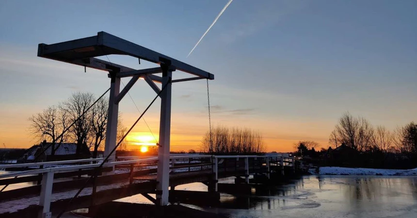 A bridge during sunrise in a winter landscape