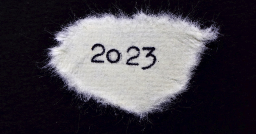2023 typed on a piece of torn paper on a black background