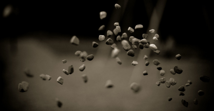 Throwing Stones - One of the official Ubuntu 9.10 wallpapers. Showing a few stones in the air on a blurry background.