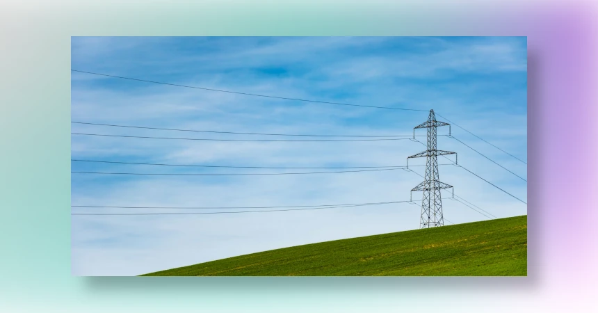 Power lines on a green grass hill